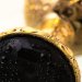 Маленькая золотистая анальная втулка с чёрным кристаллом - 7,2 см.
